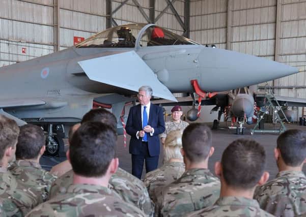 Secretary of State for Defence Michael Fallon speaks to pilots and ground crew at RAF Akrotiri in Cyprus. Picture: Nick Ansell/PA Wire