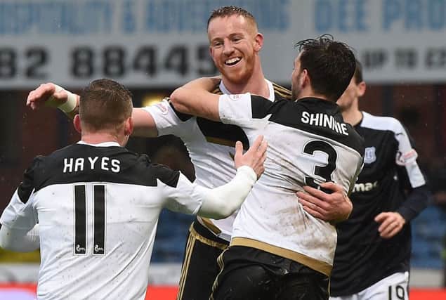 Adam Rooney celebrates with his team-mates after scoring Aberdeen's second goal and helping to make the Pittodrie sides  'lost October' a distant memory. Picture: SNS