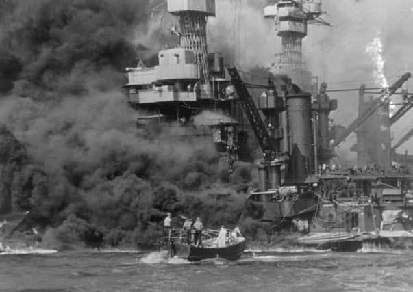 A small boat rescues sailors from the USS 'West Virginia' after she had suffered a hit in the Japanese attack on Pearl Harbor. Picture: Fox/Getty