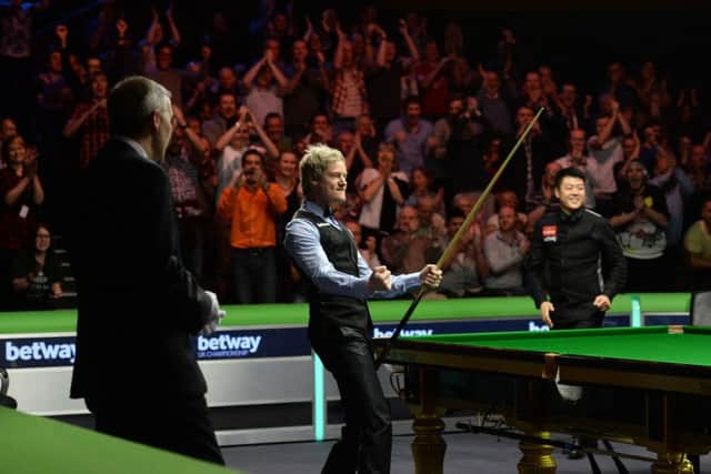 Neil Robertson celebrates knocking in the final black of his 147. Picture: PA