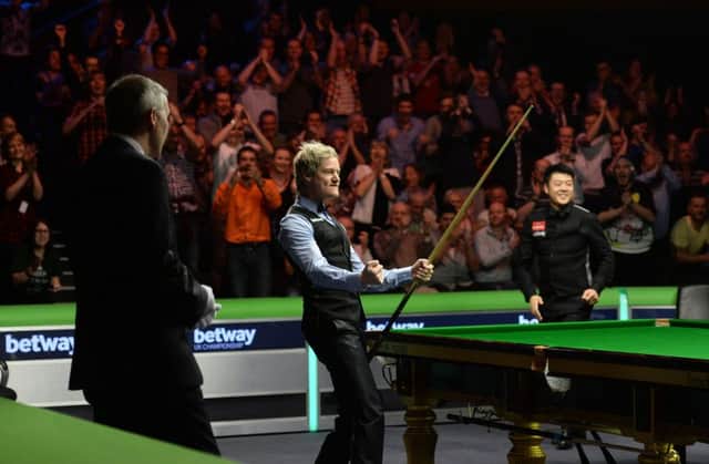 Neil Robertson celebrates knocking in the final black of his 147. Picture: PA