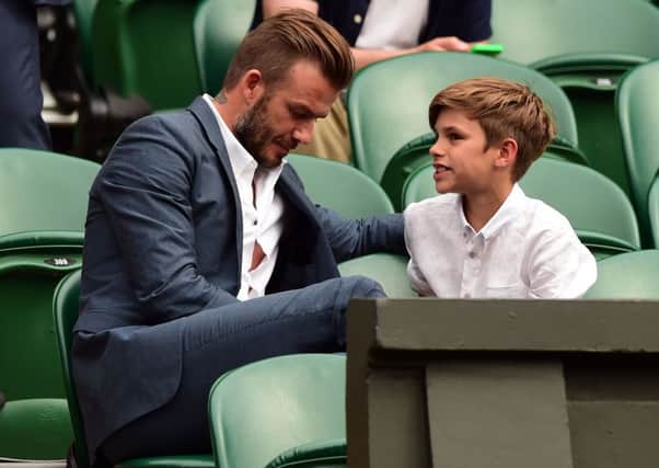 David Beckham and his son Romeo. Picture: PA