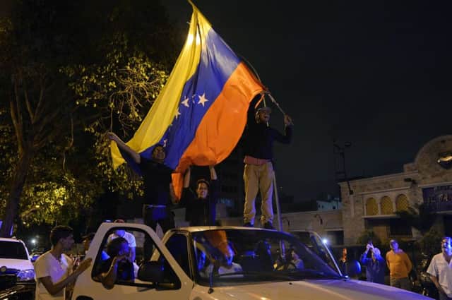 Venezuelan opposition supporters celebrate the results of the legislative election in Caracas. Picture: Getty