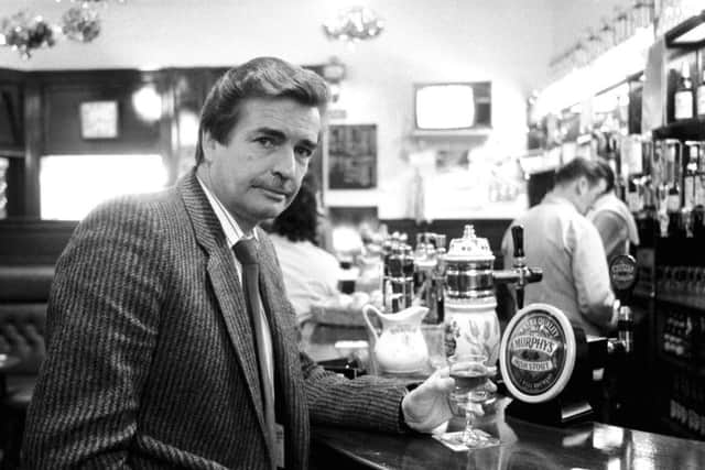 William McIlvanney enjoys a drink in Clark's Bar in Edinburgh in January 1989. Picture: TSPL