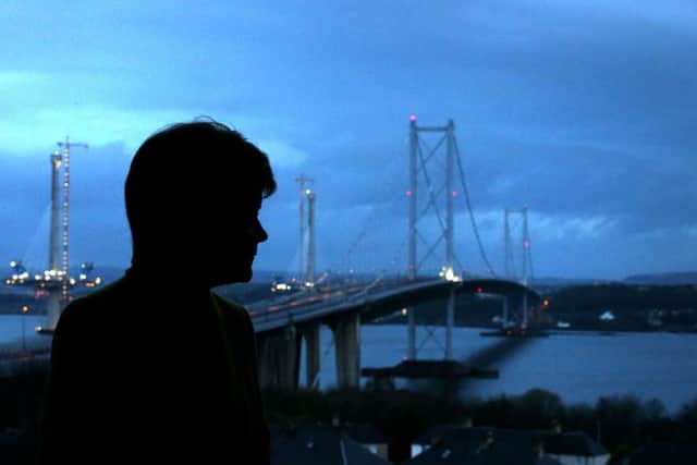 Nicola Sturgeon surveys the deserted Forth Road Bridge as work goes on to fix a crack. Picture: PA