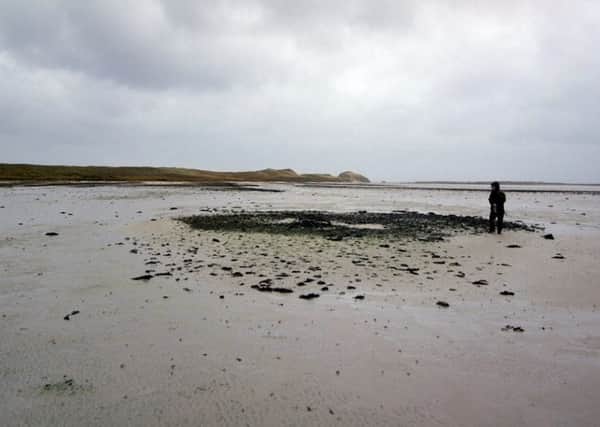 The remnants of the Bronze Age settlement at low tide at Tresness, Sanday, Orkney