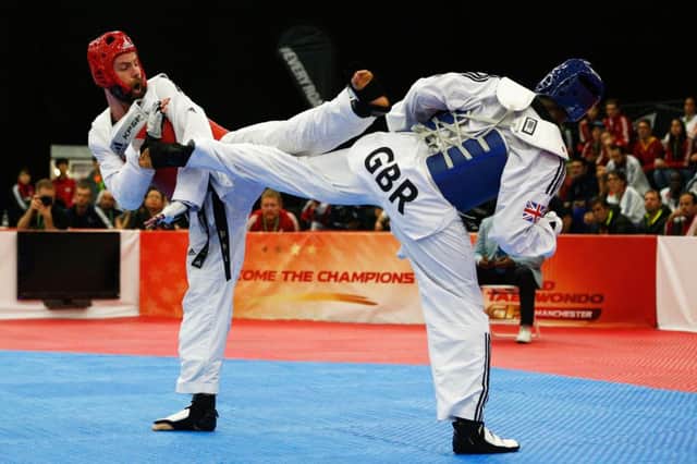 Britons Damon Sansum, left, and Lutalo Muhammad battle it out at the World Grand Prix in Manchester. Picture: Getty