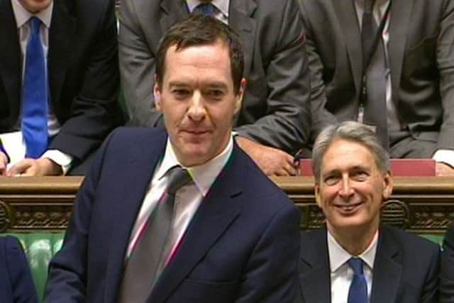 Chancellor of the Exchequer George Osborne watched by Defence Secretary Philip Hammond  PA Wire