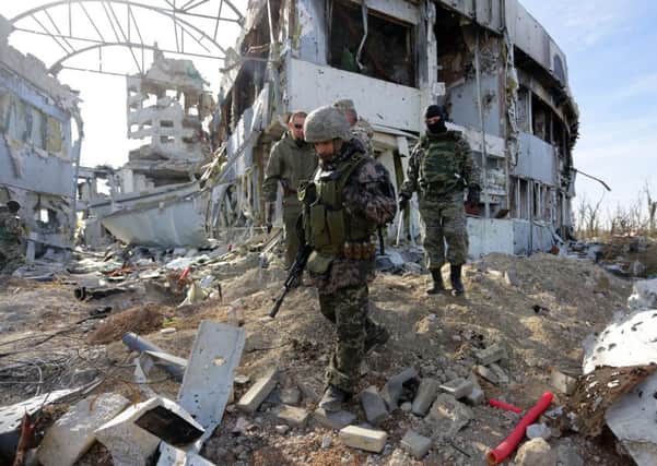 Pro-Russian rebels search for explosive devices in the Donetsk airport in Ukraine. Picture: AFP/Getty Images