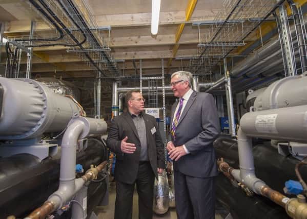 Russ Burton, CEO of SHARC Energy Systems in the new plant with energy minister Fergus Ewing. Photo: Rob Gray