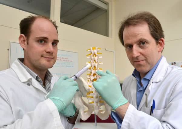 Jordan Conway (left) and Prof. Iain Gibson (right) from SIRAKOSS demonstrating how a prototype of their synthetic bone graft substitute may be used.
