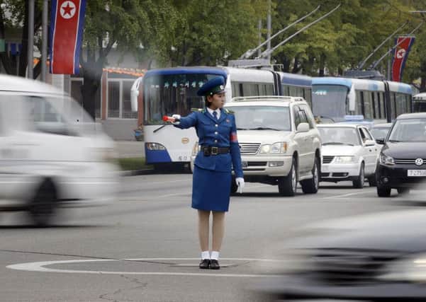 A police woman directs traffic in Pyongyang, where her services are more in demand. Picture: AP