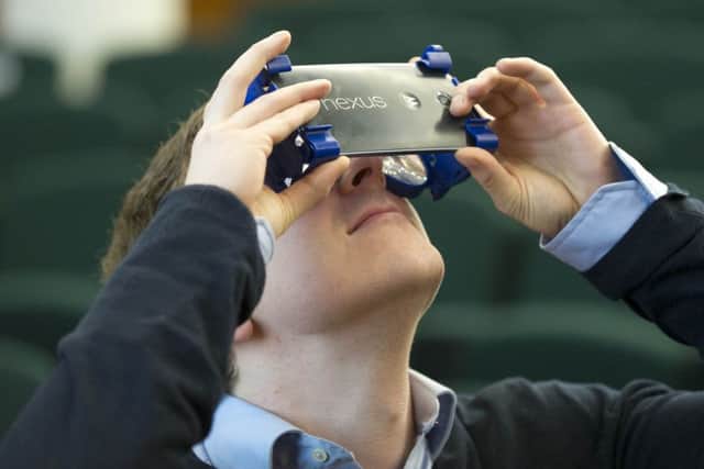 Sam Shedden tries a pair of the 360-degree Wearality glasses. Picture: Jane Barlow