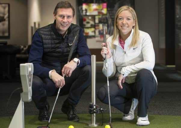 Tom Younger and professional Heather MacRae at Archerfields performance fitting centre, which is a hit with women learning golf. Picture: Lesley Martin