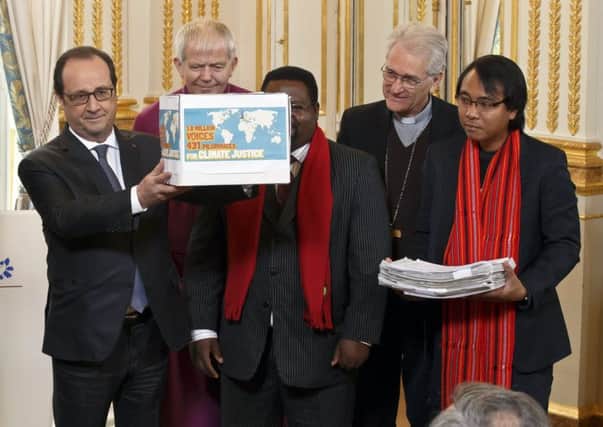 Frances president Francois Hollande with the Bishop of Salisbury Nicholas Holtam and Cameroons Augustine Njamnshi. Picture: AP
