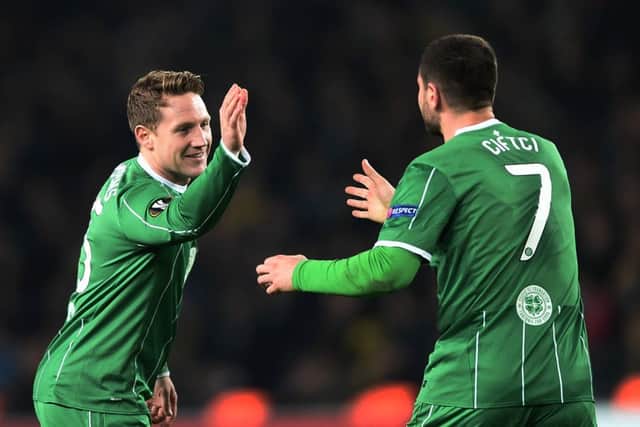 Kris Commons and Nadir Ciftci embrace after the former headed Celtic on level terms. Picture: AFP/Getty
