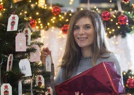 Picture: Rebecca Mitchell of Barnardo's Scotland adds the final tag to Giving Tree