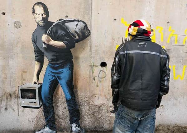Banksy's Steve Jobs mural on the wall of a Calais migrant camp. Picture: banksy.co.uk