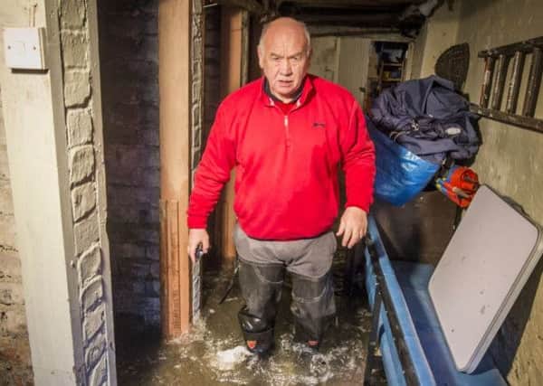Jim Renwick walks through his flooded cellar in Hawick, Scotland. Picture:  Danny Lawson/PA Wire