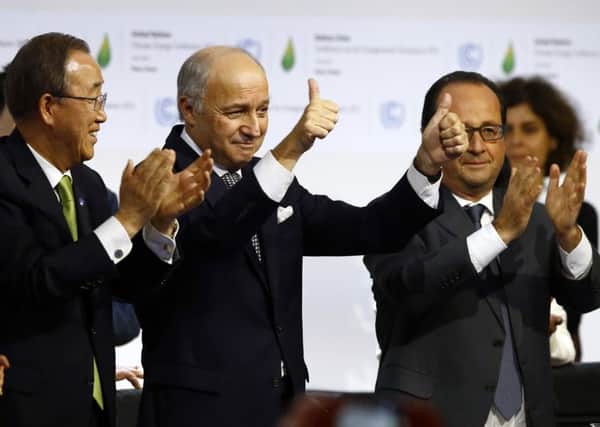 United Nations Secretary-General Ban Ki-moon, French foreign minister Laurent Fabius and President Francois Hollande applaud the deal