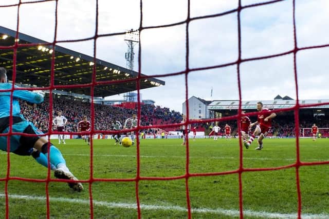 Adam Rooney converts the penalty that gave Aberdeen victory over Hearts after Jordan McGhee handled. Picture: SNS