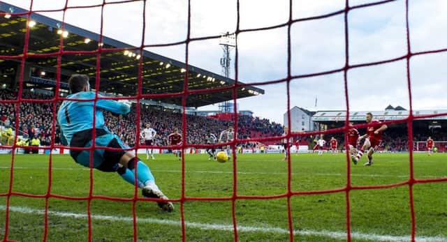 Adam Rooney converts the penalty that gave Aberdeen victory over Hearts after Jordan McGhee handled. Picture: SNS