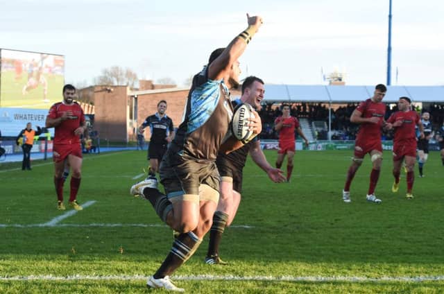 Taqele Naiyaravoro celebrates as he runs in one of his three tries against Scarlets during Glasgow's first win in Europe this season. Picture: SNS