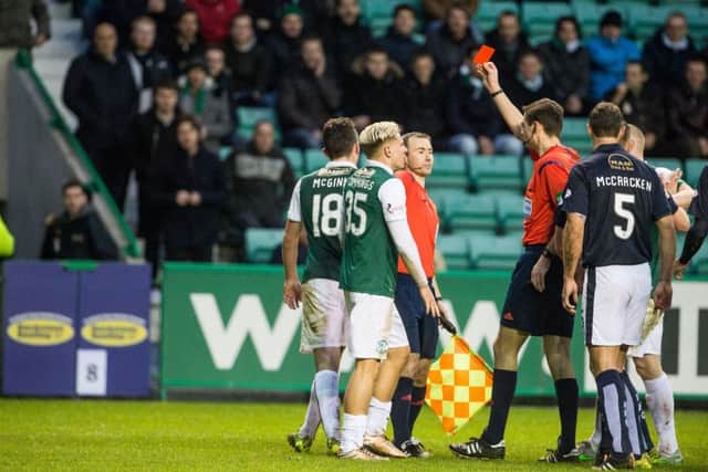Hibs midfielder John McGinn is shown a red card just before half-time at Easter Road on Saturday. Picture: Ian Georgeson