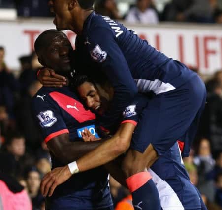 Newcastle goal hero Ayoze Perez is mobbed by Moussa Sissoko, left, and Georginio Wijnaldum. Picture: Getty