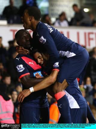 Newcastle goal hero Ayoze Perez is mobbed by Moussa Sissoko, left, and Georginio Wijnaldum. Picture: Getty