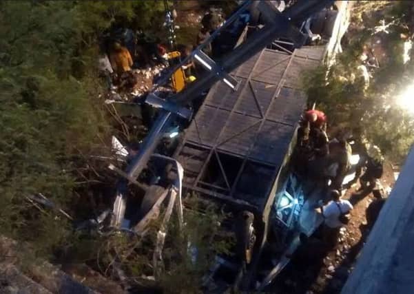 Rescuers search the wreckage of the bus, which was carrying about 60 Argentine border guards, 41 of whom were killed. Picture: AFP/Getty Images