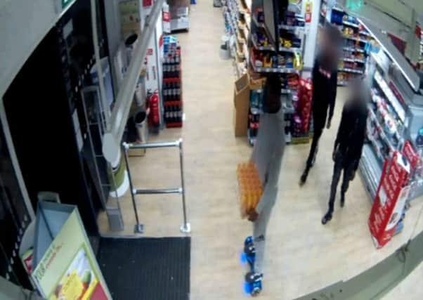 Brazen: The man leaves the Co-op store on a hoverboard, with the crate of Lucozade. Picture: Hemedia