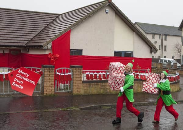 Campaigners gift wrap a full-size affordable home in Edinburgh, in a bid to raise awareness of the plight of homeless Scottish children this Christmas. Picture: Hemedia