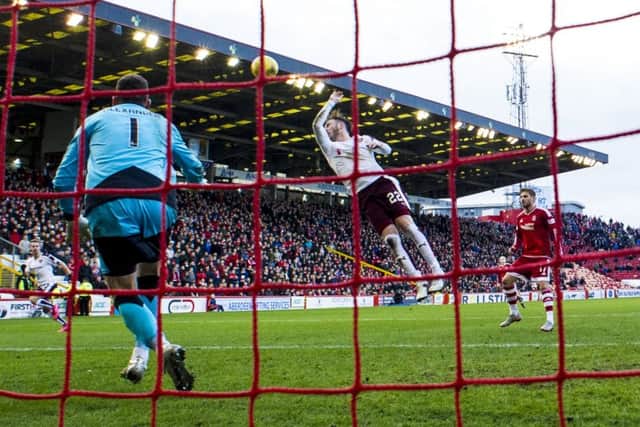 The bizarre moment at Pittodrie when Jordan McGhee reached up to handle Kenny McLeans cross in the box. Picture: SNS