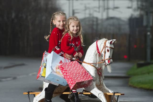Orla and Mara Livingston from Erskine deliver sack fulls of presents they have  raised for charity.
