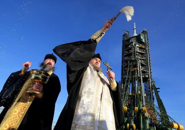 A Russian Orthodox priest blesses the media and well-wishers after a service at the Baikonur Cosmodrome in Kazakhstan. Picture: PA