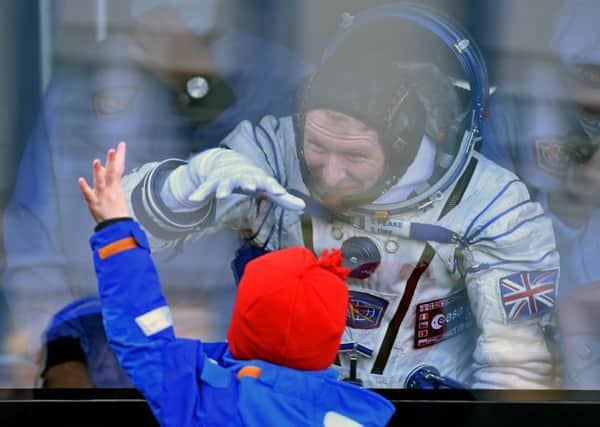 UK astronaut Maj Peake waves goodbye to one of his sons before the launch. Picture: AFP/Getty Images