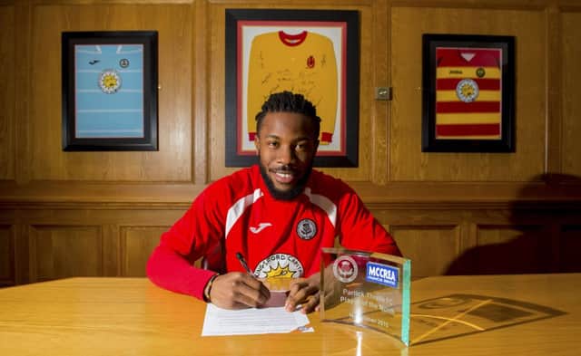 Partick Thistle's Mustapha Dumbuya is happy to have signed a contract extension at the club. Picture: SNS