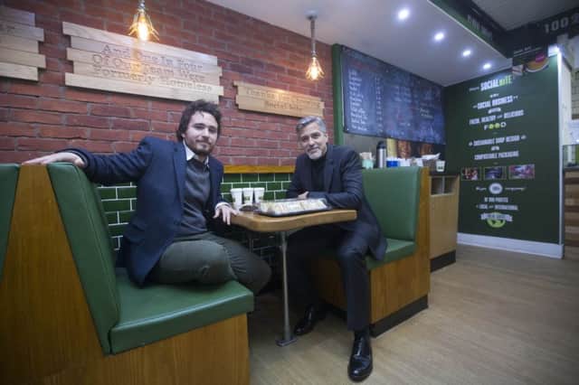 George Clooney meeting owner Josh Littlejohn as he visits Social Bite. Picture: Jeff Holmes/PA Wire