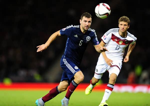 James McArthur vies for the ball with Germany's Thomas Muller at Hampden in September. Picture: Michael Gillen
