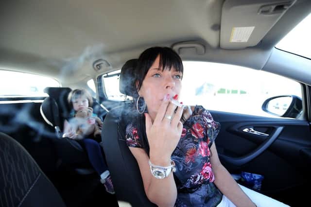 Smoking in cars with children has been banned. Picture posed by models. Picture: John Devlin