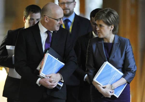 John Swinney on his way to unveil his draft budget to MSPs. Picture: Neil Hanna