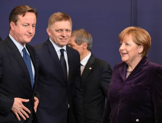 David Cameron, Slovakian prime minister Robert Fico and Angela Merkel at the EU summit. Picture: AFP/Getty Images