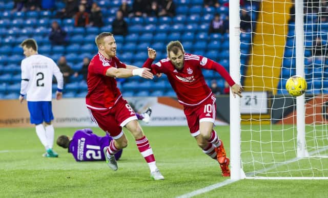 Aberdeen's Niall McGinn celebrates after heading home his sides opening goal. Picture: SNS