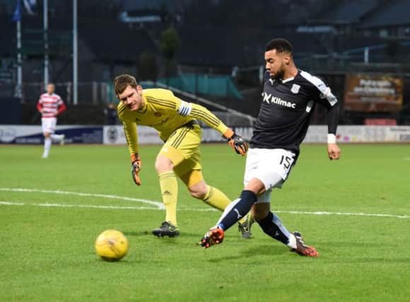 Kane Hemmings (right) slots the ball home to open the scoring for Dundee. Picture: SNS