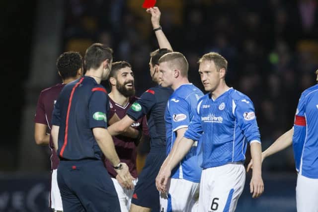 Hearts' Juanma Delgado (3rd from left) is shown a red card. Picture: SNS