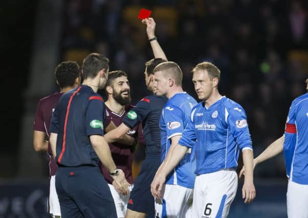Hearts' Juanma Delgado (3rd from left) is shown a red card. Picture: SNS