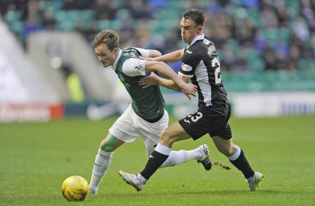 Liam Henderson and Jordan Marshall challenge for the ball. Picture: TSPL
