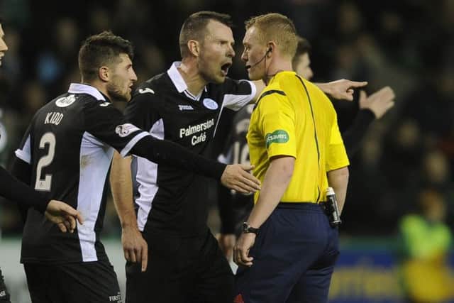 Andy Dowie, centre, leads the protests to referee Brian Colvin at full-time. Picture: Neil Hanna