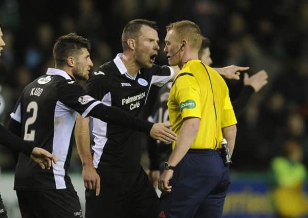 Andy Dowie, centre, leads the protests to referee Brian Colvin at full-time. Picture: Neil Hanna